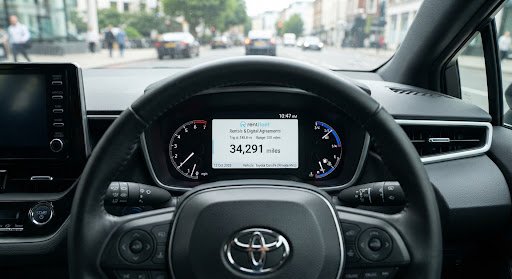 Clean dashboard digital odometer showing vehicle mileage 34,291 miles on dashboard screen inside private hire vehicle